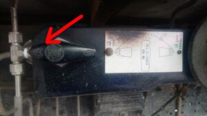 Valve with warning label and arrow